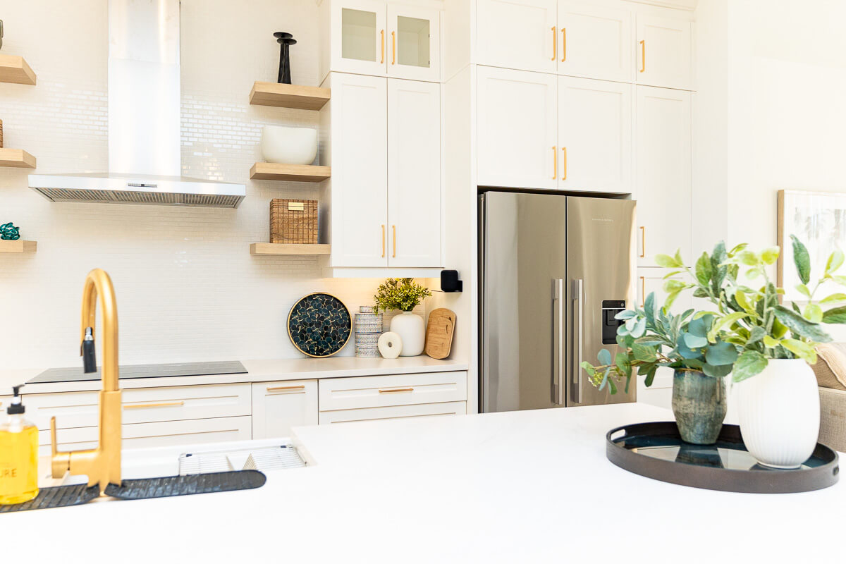 Bright modern kitchen with stainless steel fridge and decor, real estate photography Toronto interior