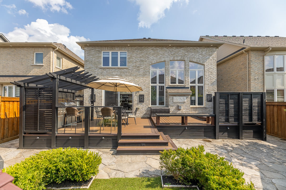 Backyard deck with pergola and outdoor seating, exterior real estate photography Toronto