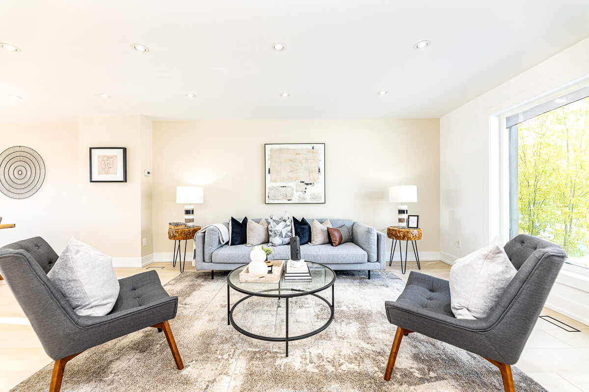 Cozy living room with sofa and armchairs, staged home photography Toronto