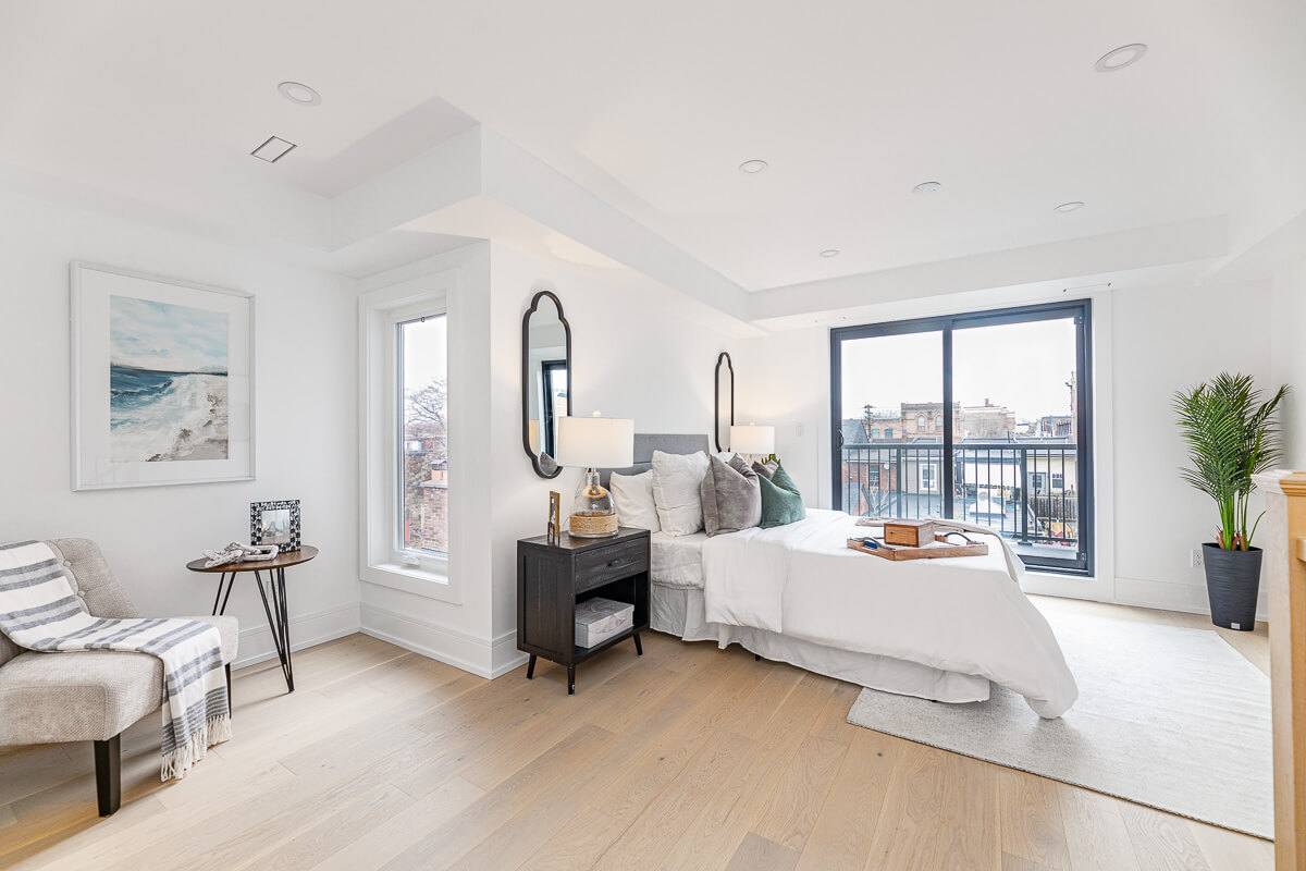 Minimalist bedroom with large windows and balcony, condo bedroom photography Toronto