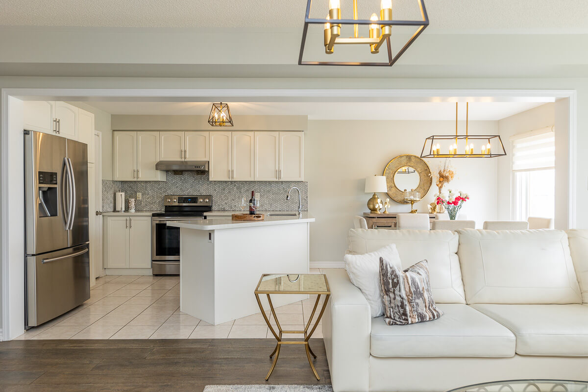 Bright kitchen and dining space with white cabinets, Toronto real estate interior photography