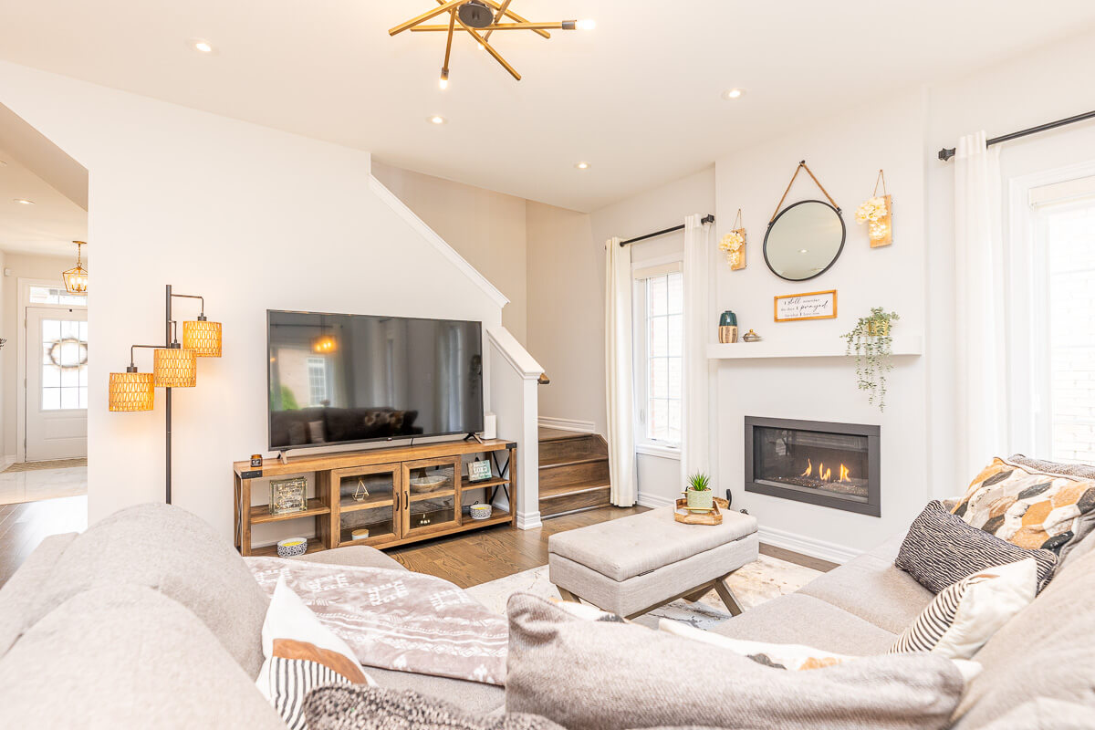 Cozy living room with fireplace and TV area, residential real estate photography Toronto