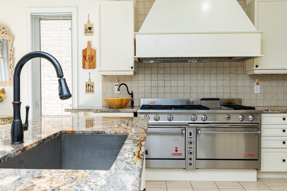 Classic kitchen with granite countertop and stainless steel stove, real estate photography Toronto interior