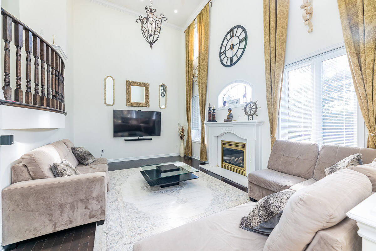 Spacious living room with fireplace, high ceilings and large windows, luxury real estate photography Toronto