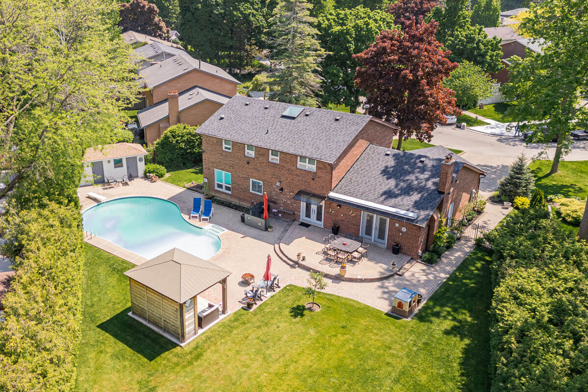 Detached house with backyard pool and patio, drone real estate photography Toronto