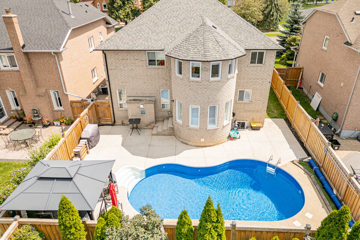 Backyard with swimming pool and fenced property, aerial real estate photography GTA
