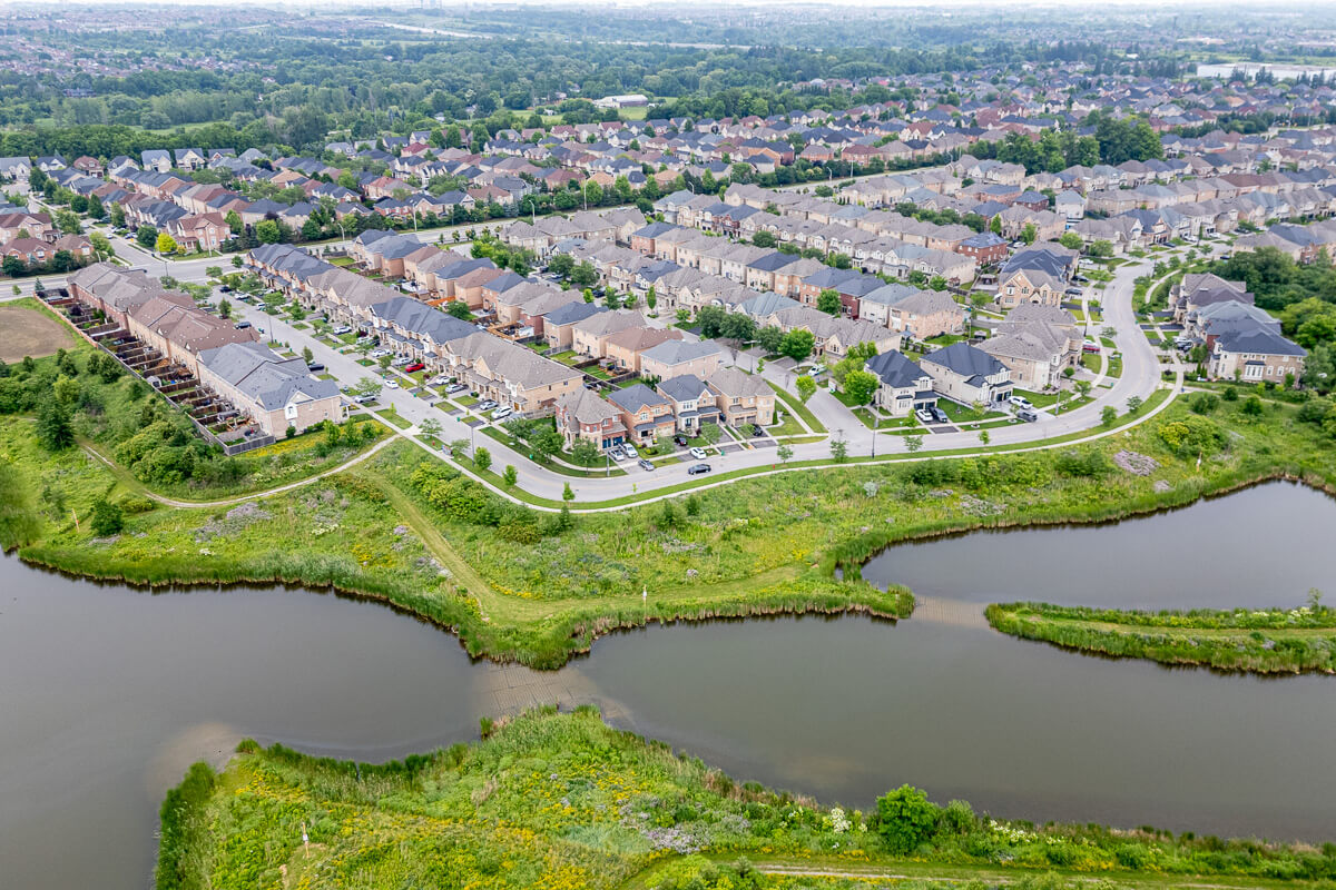 Aerial view of lakeside community with docks and shoreline, drone photography real estate Ontario
