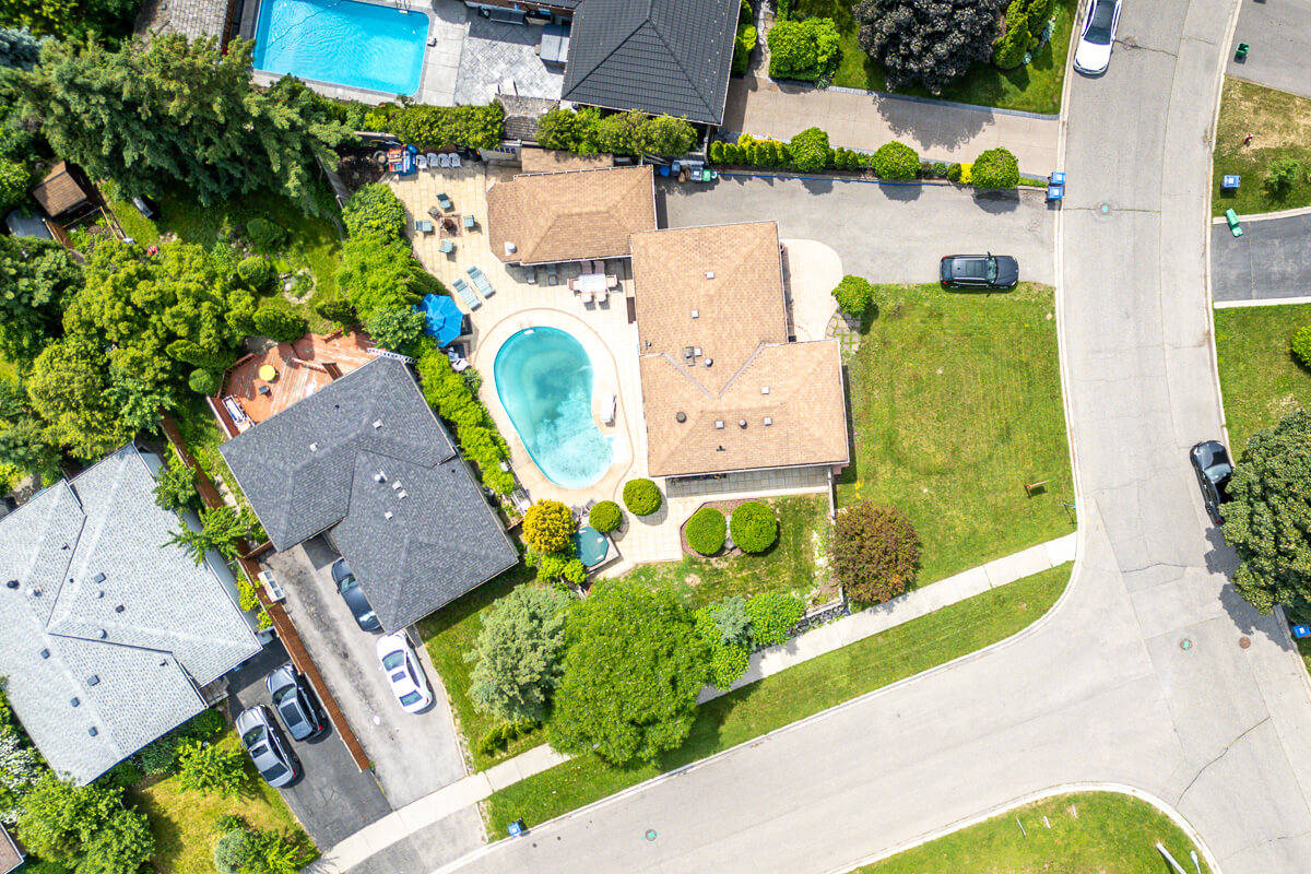 Top down aerial of backyard patio with outdoor furniture and umbrellas, drone real estate photography Toronto
