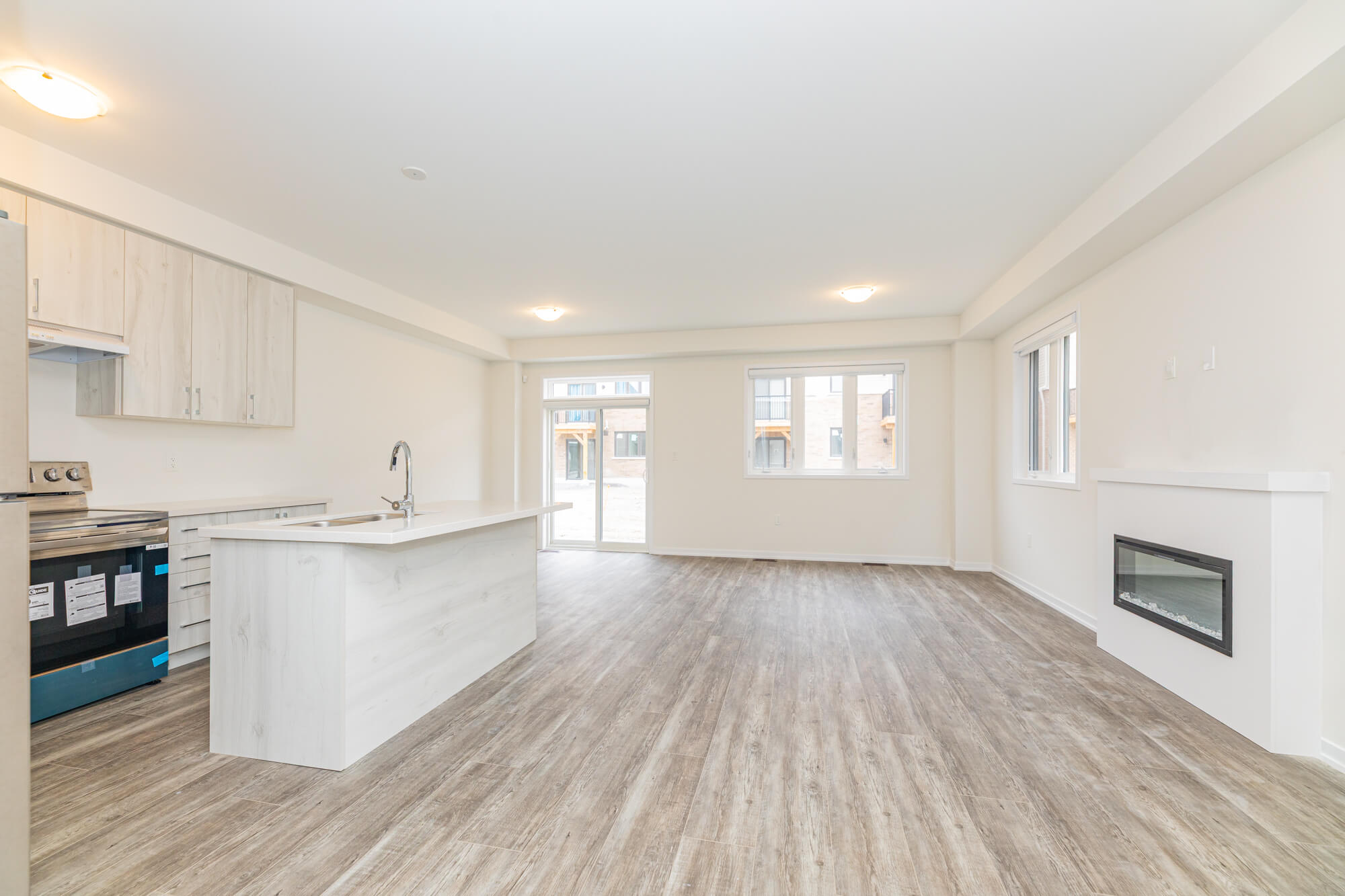 Empty open concept living space before virtual staging in North York house with kitchen and hardwood floor
