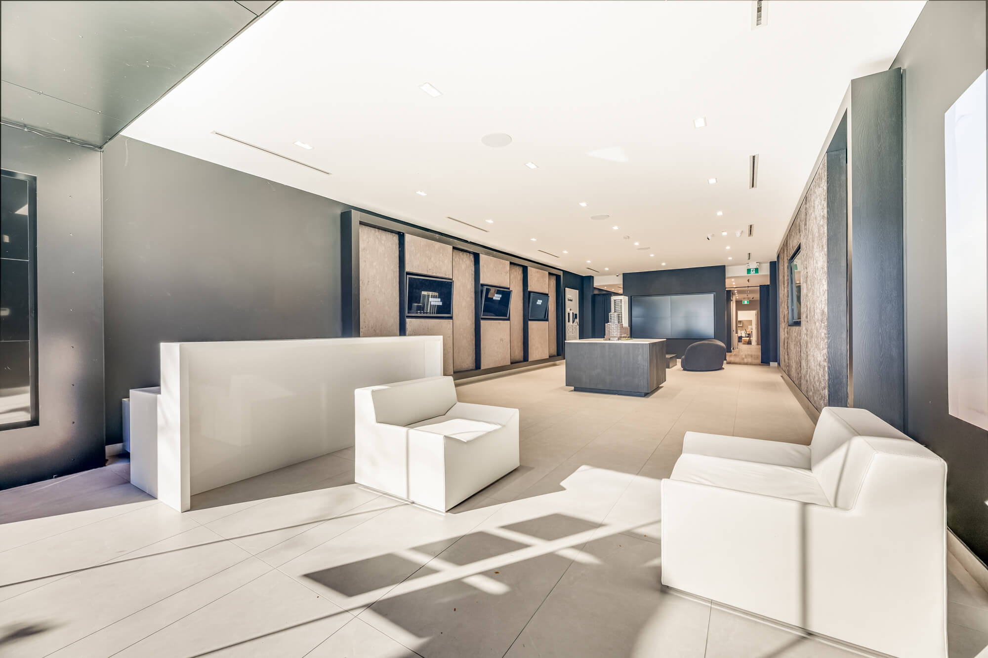 Commercial presentation centre photography in Toronto GTA showing lounge seating and display wall